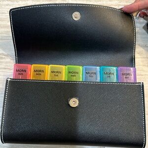 Weekly pill organizer. Great for travel. Never used.